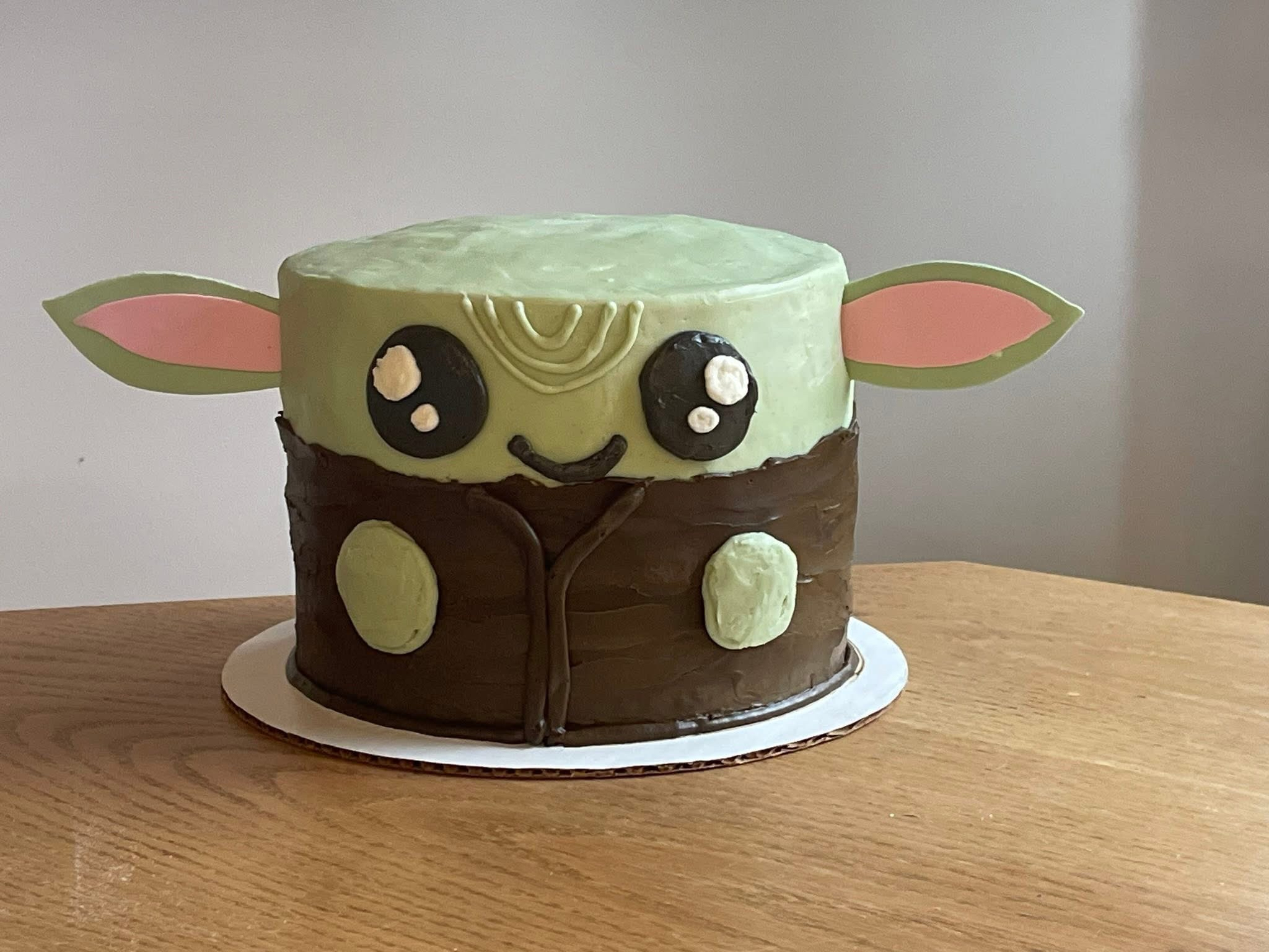 Novelty birthday cake decorated to look like Baby Yoda
